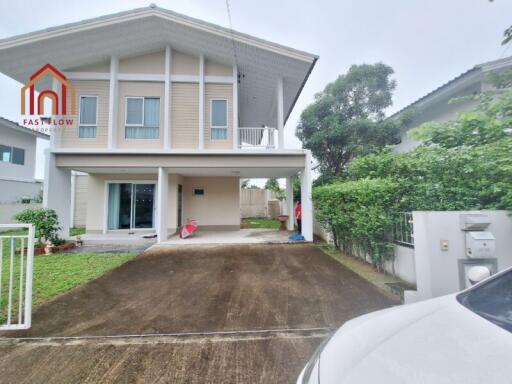 Front view of a two-story house with a driveway and front lawn