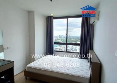 Modern bedroom with large window and city view