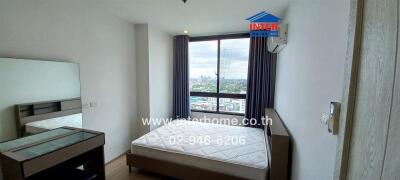 Modern bedroom with large window and city view