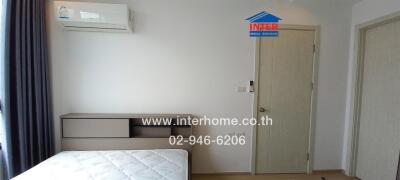 bedroom with air conditioner, bed, and built-in furniture