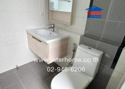 Modern bathroom with sink, toilet, and mirror