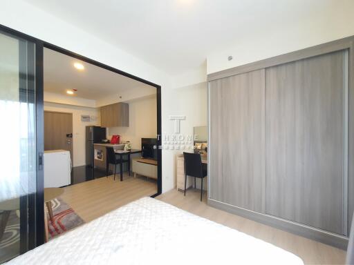 View of a studio apartment with open partitioned bedroom, kitchen, and dining area