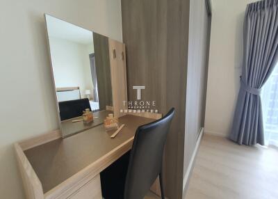 Bedroom with vanity desk and mirror next to wardrobe