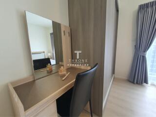 Bedroom with vanity desk and mirror next to wardrobe