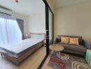 Bedroom view with a bed, sofa, table, and large sliding glass door