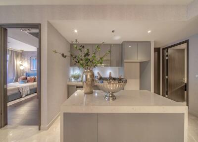 Modern kitchen with island and view into bedroom