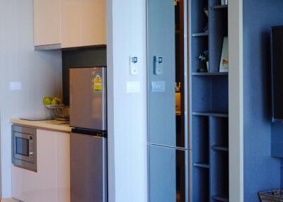 Modern kitchen space with adjacent living area and storage unit