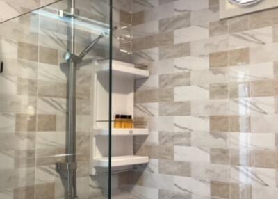 Modern bathroom with glass shower and tiling
