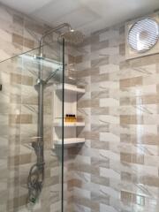 Modern bathroom with glass shower and tiling