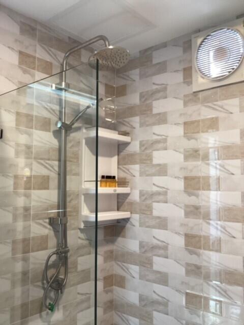 Modern bathroom with glass shower and tiling