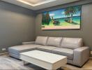 Modern living room with a gray sectional sofa and a tropical painting