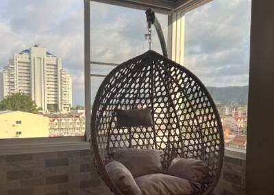 Balcony with hanging chair and city view