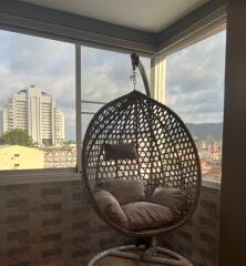 Balcony with hanging chair and city view