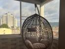 Balcony with hanging chair and city view