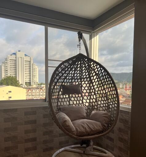 Balcony with hanging chair and city view