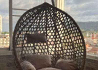 Wicker swing chair on balcony