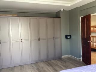 Spacious bedroom with ample closet space and security safe