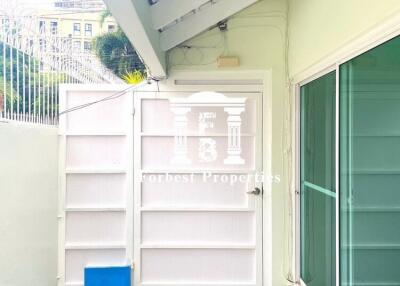 Covered outdoor patio area with wall and glass sliding door