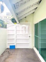 Covered outdoor patio area with wall and glass sliding door