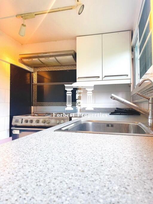 Modern kitchen with stove, sink, and cabinets