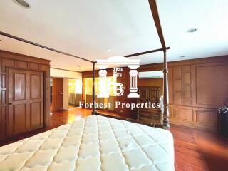 Spacious bedroom with wooden furniture and four-poster bed