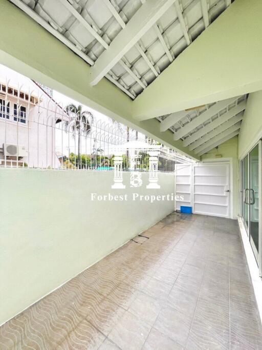 Covered outdoor area with tiled flooring and white gate