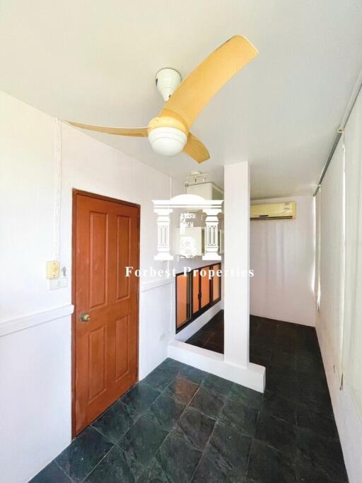 Room with orange door, ceiling fan, and air-conditioner