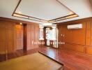 Spacious living room with wooden floors and paneling