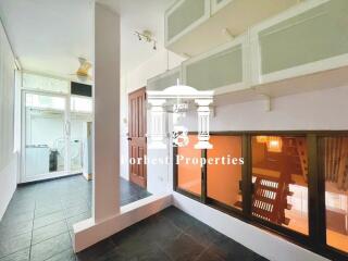 A spacious indoor area with a large window and frosted glass cabinets