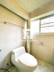 Modern bathroom with tiled walls and window