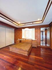 Spacious bedroom with wooden flooring and built-in wardrobe