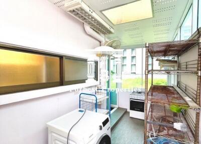 Laundry room with washing machine and shelving