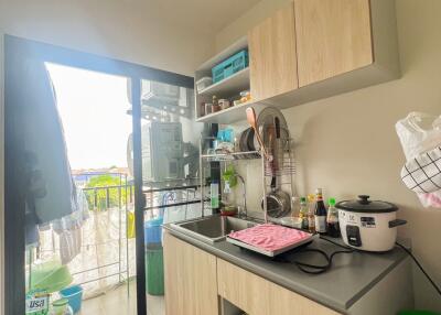 Modern compact kitchen with balcony access