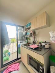 Modern compact kitchen with balcony access