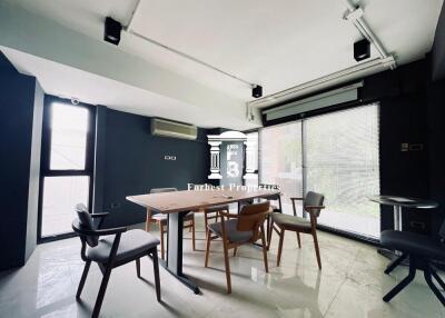 Modern dining area with large windows and contemporary furniture