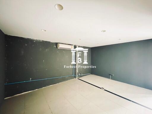 Spacious empty room with air conditioning and tiled floor