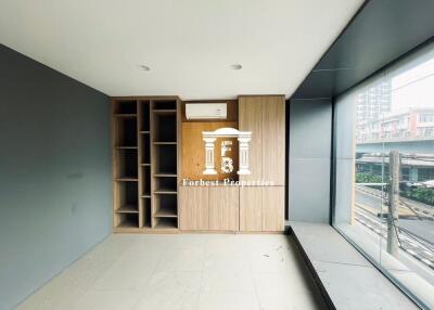 Unfurnished room with large window and city view