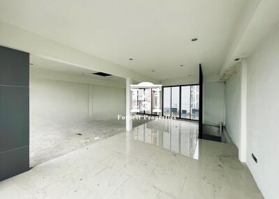 Spacious empty living room with large windows