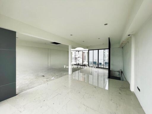 Spacious empty living room with large windows