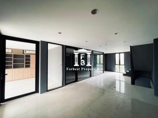 Modern open living area with large windows and built-in shelving