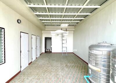 Utility room with storage tanks and multiple doors