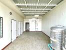 Utility room with storage tanks and multiple doors