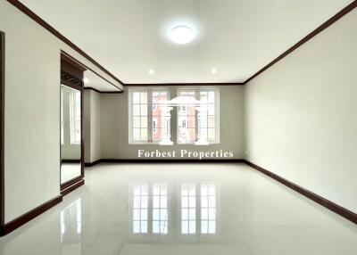 Spacious living room with large windows and floor tiles