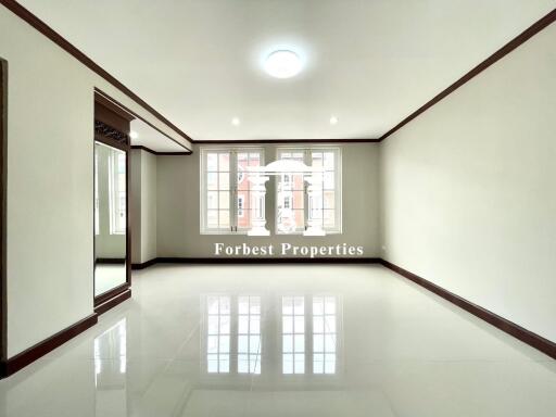 Spacious living room with large windows and floor tiles