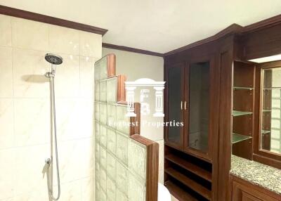 Bathroom with shower and wooden cabinets