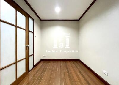 Empty room with wooden floor and frosted glass door