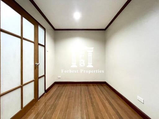 Empty room with wooden floor and frosted glass door