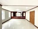 Spacious main living area with glossy white tile flooring and wooden accents