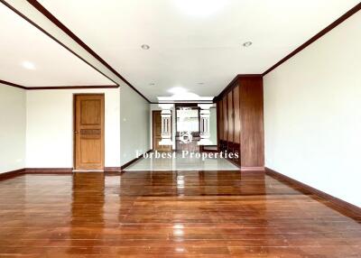 spacious empty room with wooden flooring and wooden accents on ceiling and doors