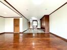 spacious empty room with wooden flooring and wooden accents on ceiling and doors